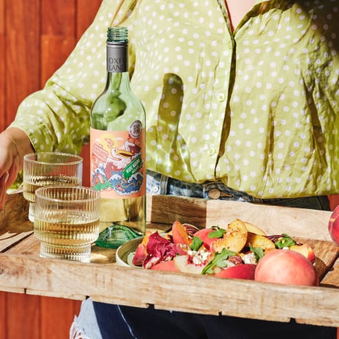 There's no better way to celebrate the season than with a delectable peach salad paired with a bottle of Riverlife Wake Making Moscato.