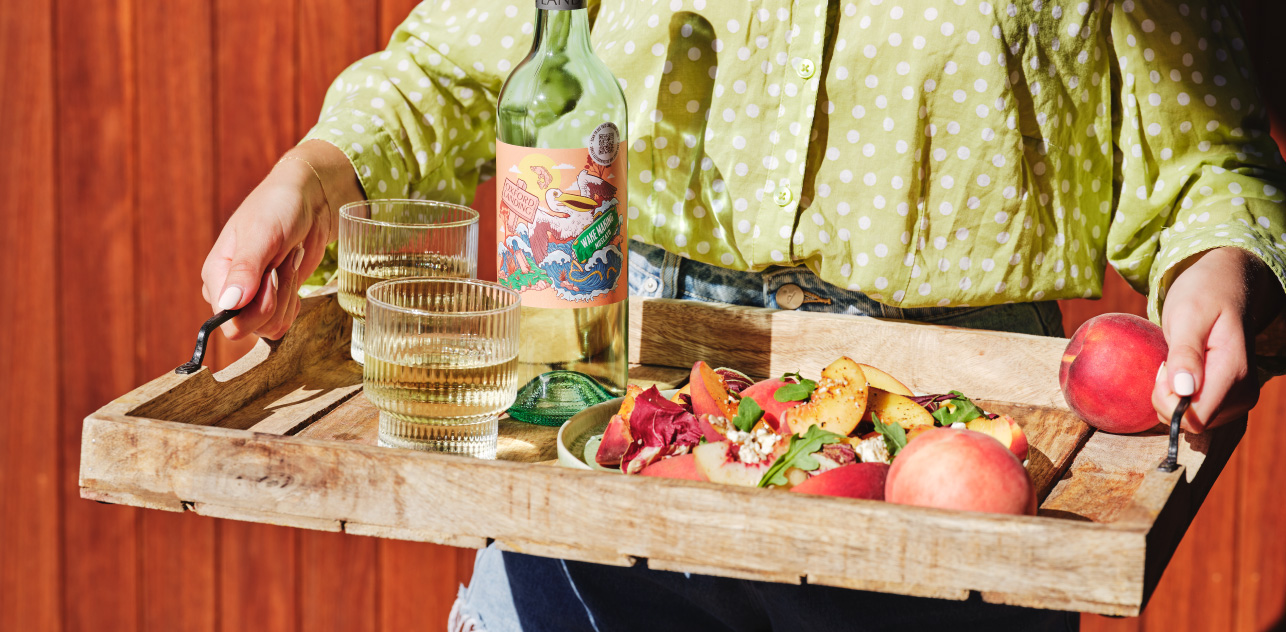 There's no better way to celebrate the season than with a delectable peach salad paired with a bottle of Riverlife Wake Making Moscato.